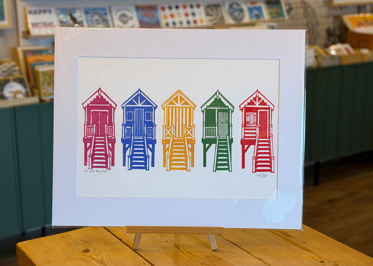 Multi-coloured linocut of Wells beach huts